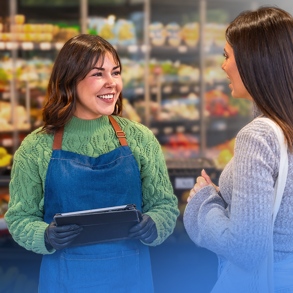 Retail worker helping a customer with a tablet